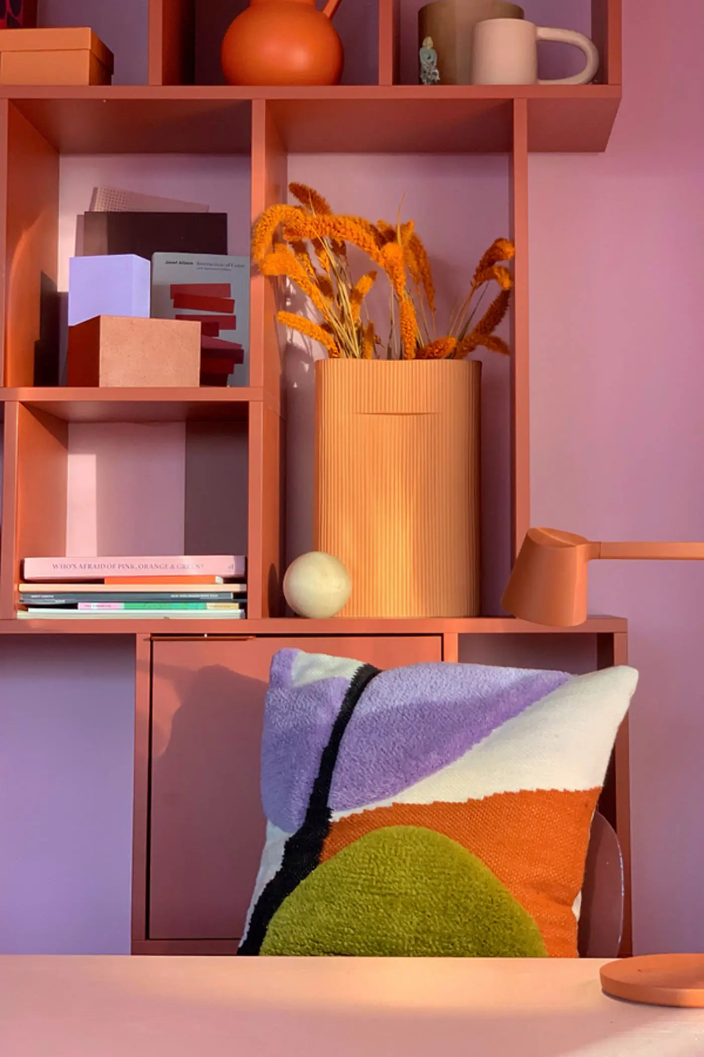 A tufted Proba Home cushion in a colour-matched interior