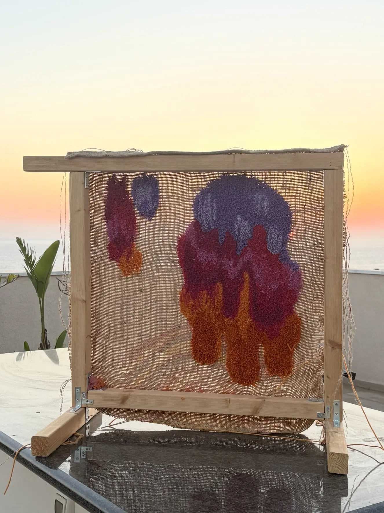 Jan Fechner's drip tufting frame on the roof in Paphos at sunset